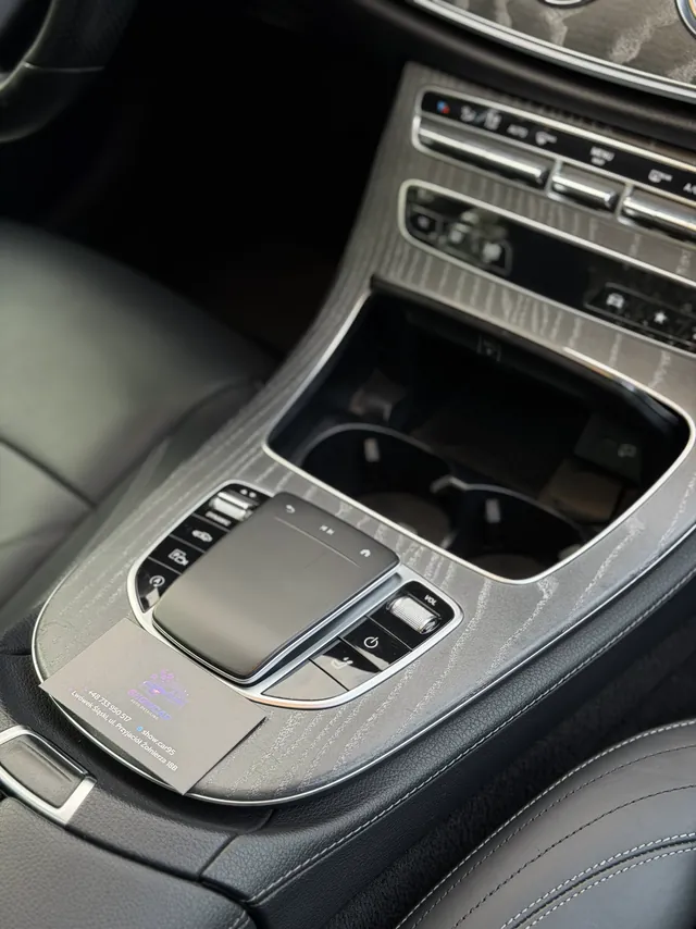 Konsola środkowa Mercedesa E-Class z gładzikiem i panelem w drewnie, po czyszczeniu